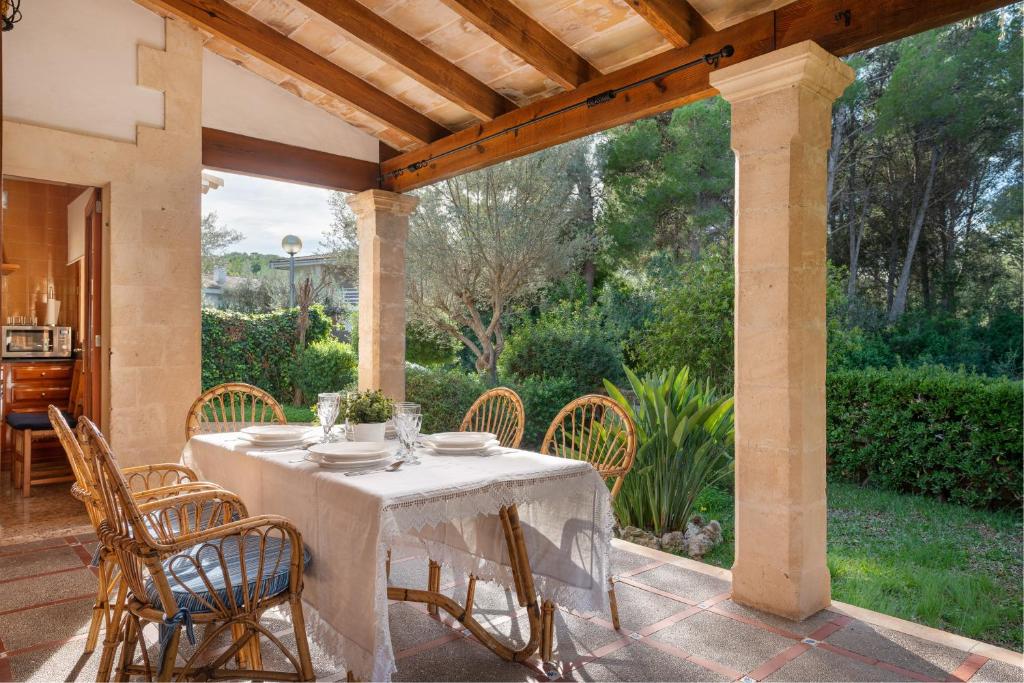 a dining table and chairs on a patio at Chalet Son Gomila in the North of Mallorca in Cielo de Bonaire 