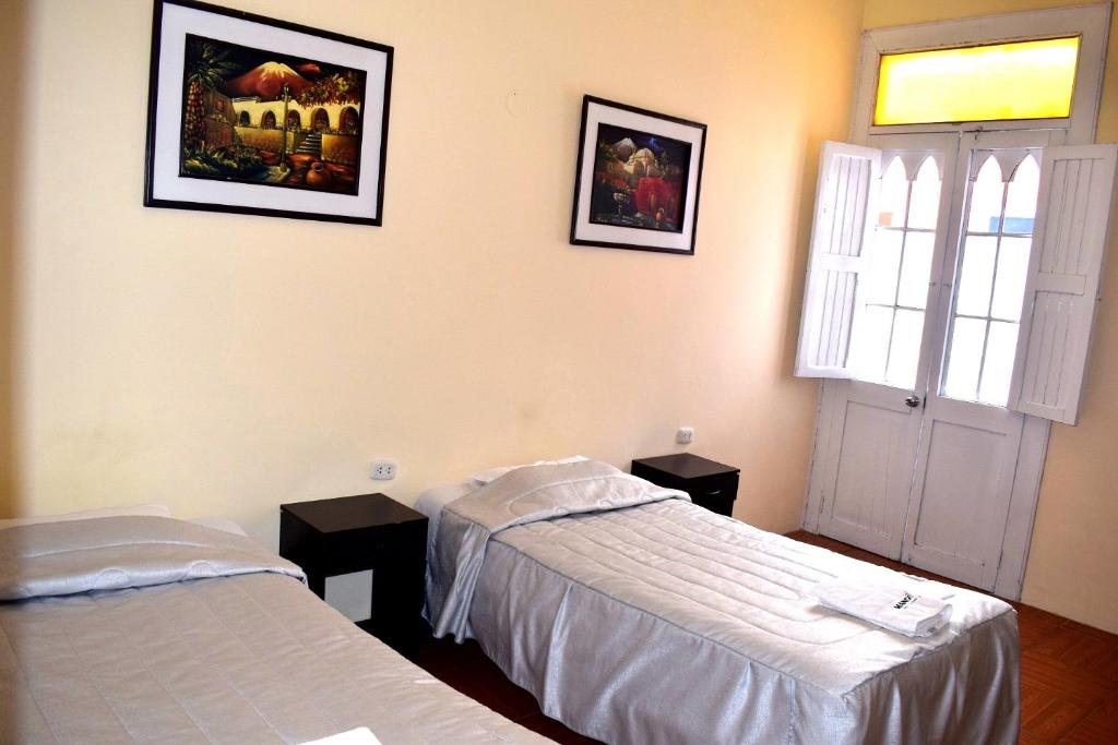 Postel nebo postele na pokoji v ubytování Mango Hostel B&B