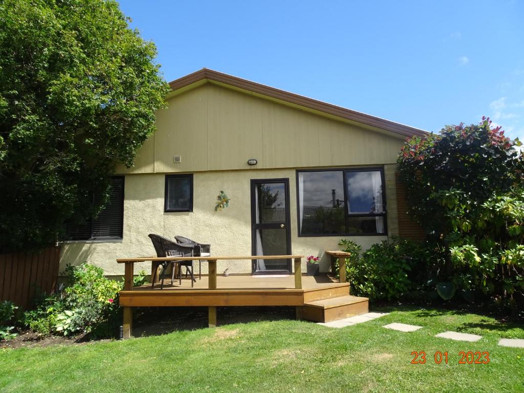 a house with a wooden deck in front of it at Nangari Studio Unit in Alexandra