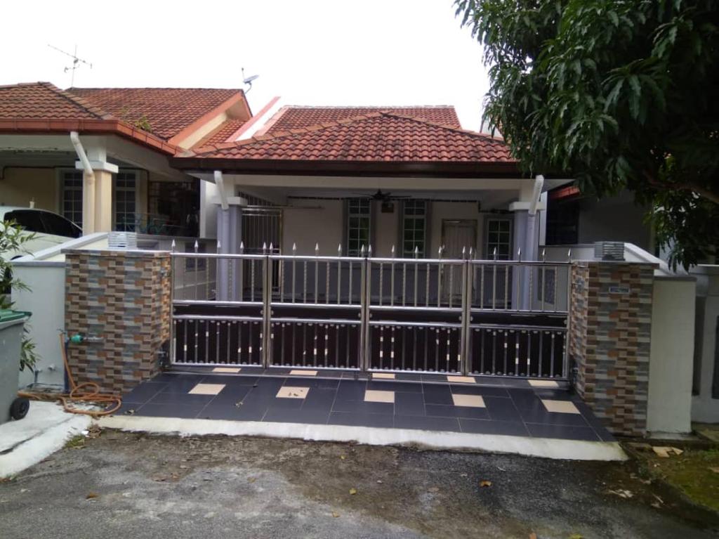 a house with a gate and a fence at ISMAYUS GUESTHOUSE in Kampong Chinchang