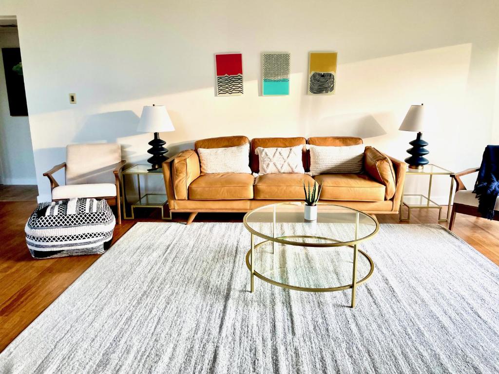 a living room with a couch and a table at Newly Remodeled Mid-Century Modern Lake Condo in Lake Geneva