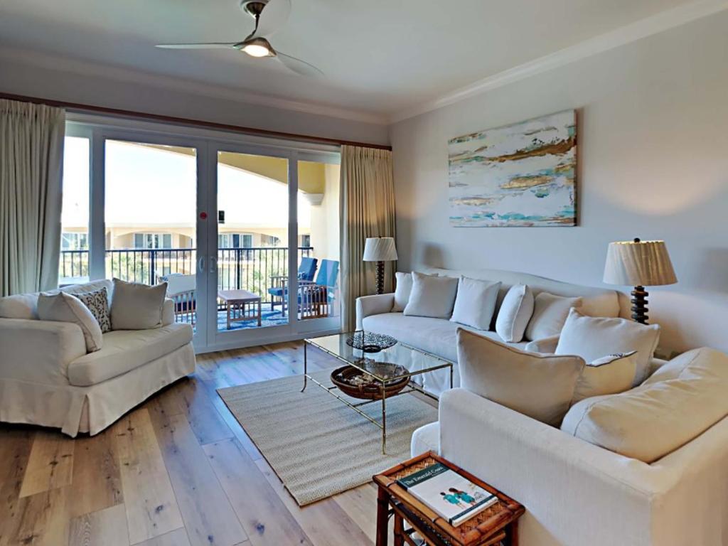 a living room with two white couches and a balcony at Adagio 303E in Santa Rosa Beach