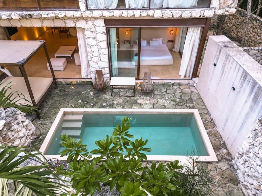 an overhead view of a swimming pool in a house at Tulum Retreat-3BR Luxury Condo-Private Pool in Tulum