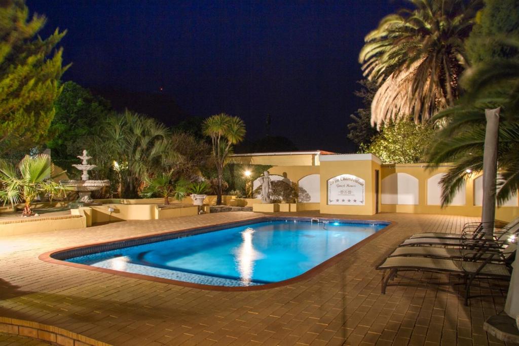 a swimming pool in a yard at night at 26 On Chamberlain Guest House in Queenstown