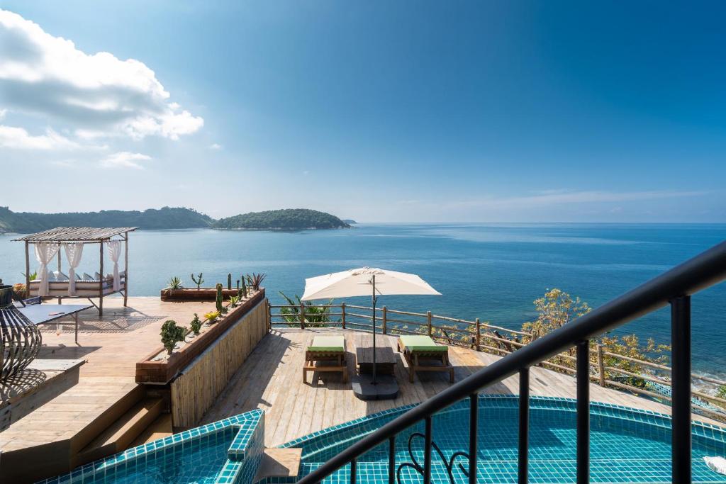 a view of the ocean from a balcony with a swimming pool at Villa at Nai Harn Cape / Ocean Point in Nai Harn Beach