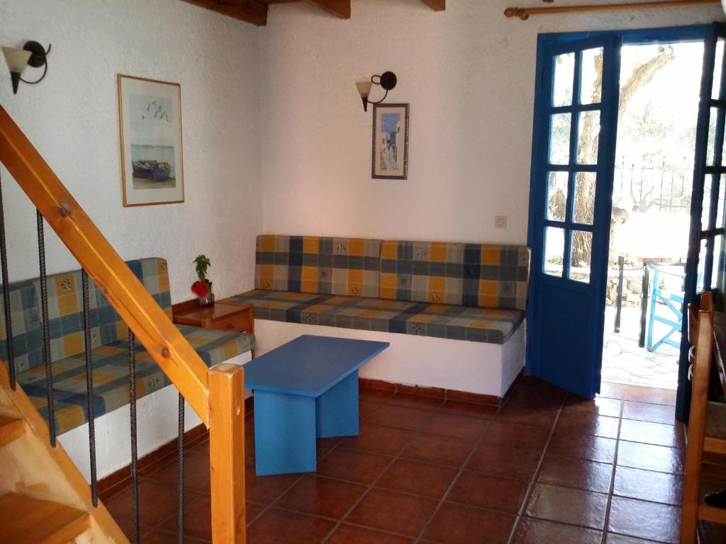 a living room with a couch and a table at S West Crete Cottage in Palaiochóra