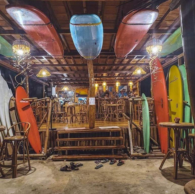 a room with surfboards on display in a restaurant at Surf and Skate Duli El Nido By Kiteclub Palawan in El Nido