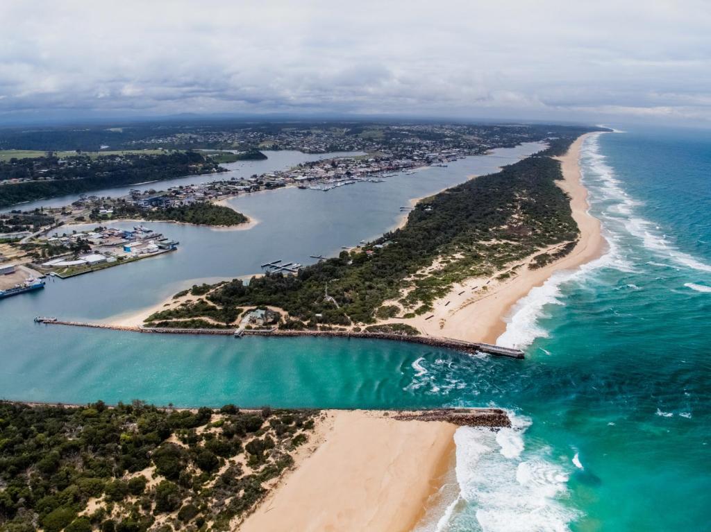 an aerial view of a beach and the ocean at Lakes Entrance Tourist Park in Lakes Entrance