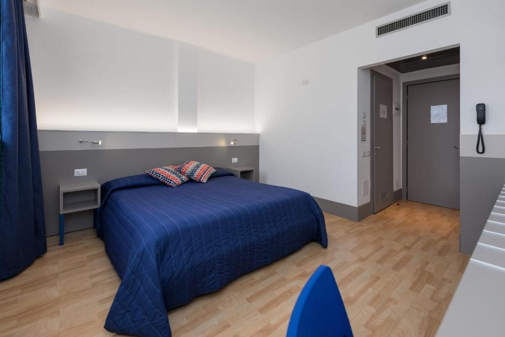 Postel nebo postele na pokoji v ubytování Hotel Martini