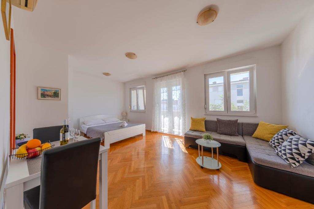 a living room with a couch and a table at Sorento Apartments in Dubrovnik