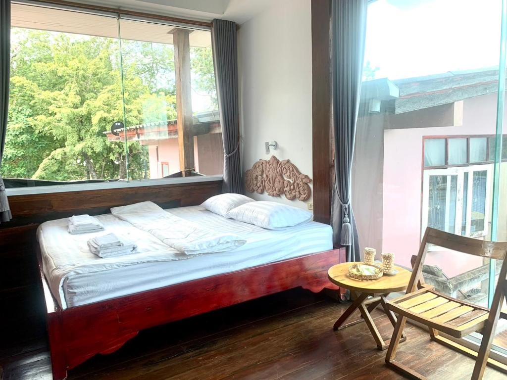 Postel nebo postele na pokoji v ubytování Une Jai Place เรือนอุ่นใจ
