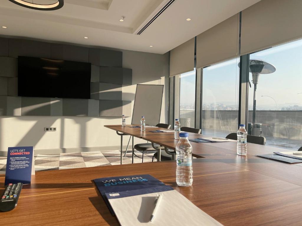 a conference room with two bottles of water on a table at Holiday Inn Express - Ankara - Airport by IHG in Ankara