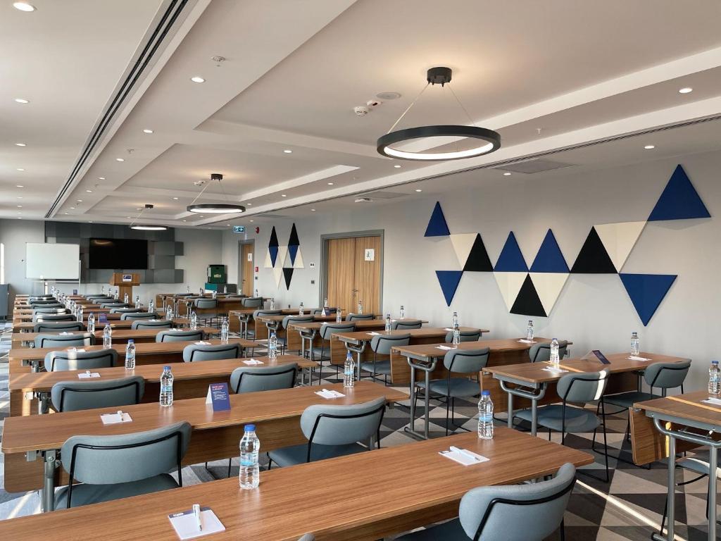 a large lecture room with tables and chairs at Holiday Inn Express - Ankara - Airport by IHG in Ankara