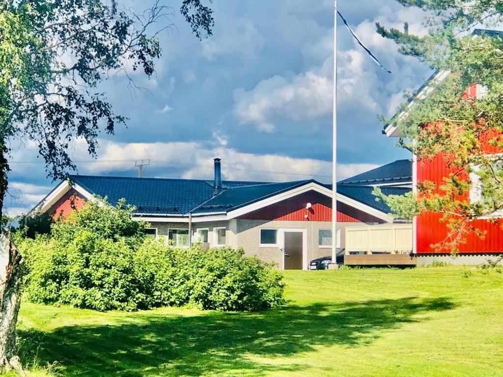 a house with a red and white building at Alanko Old Cowhouse in Tornio