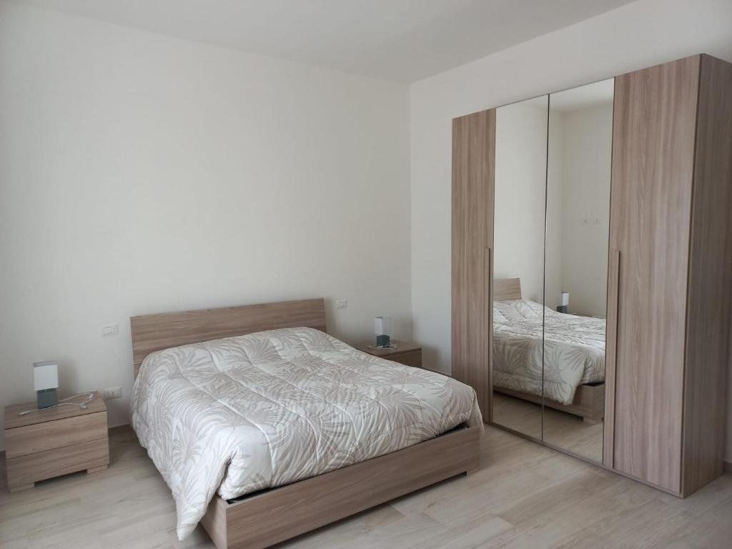 ein Schlafzimmer mit einem Bett und einem großen Spiegel in der Unterkunft Alloggio del generale in Viterbo
