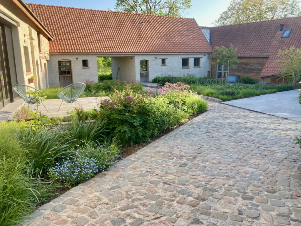 a cobblestone path in front of a house at Nachtegael Zomerhuis, idyllische woning in de Vlaamse Ardennen in Kluisbergen