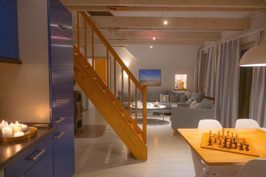 a living room with a staircase and a living room with a chess board at Scirocco in Westermarkelsdorf