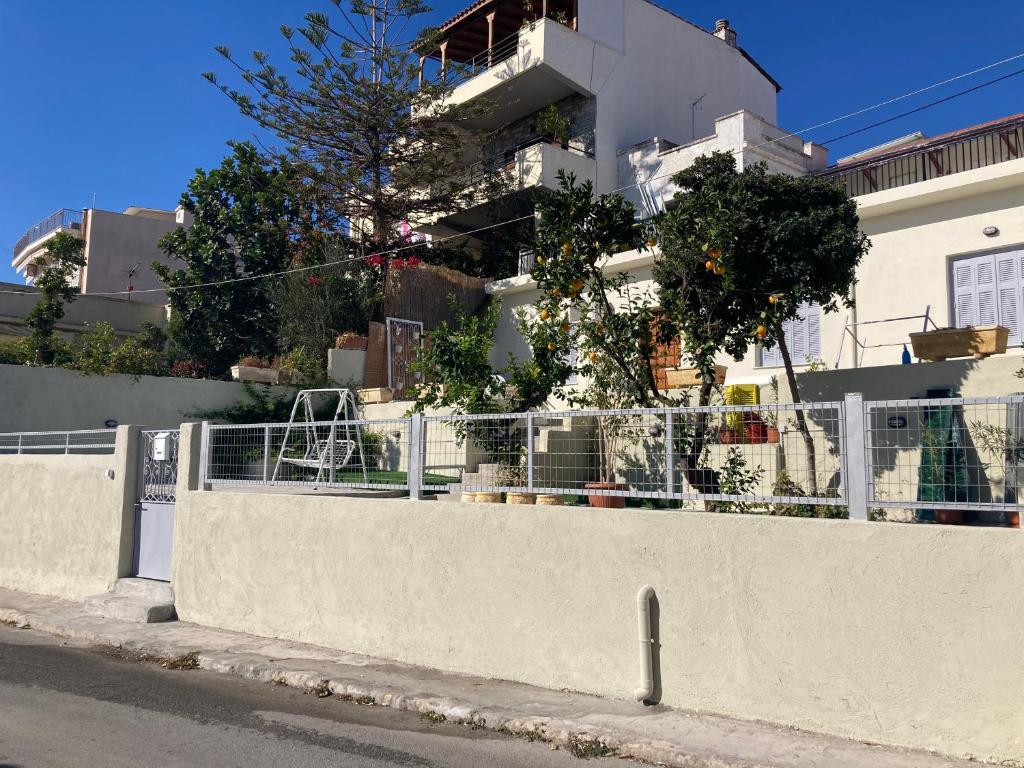 a white fence in front of a building at Lemonia in Megara