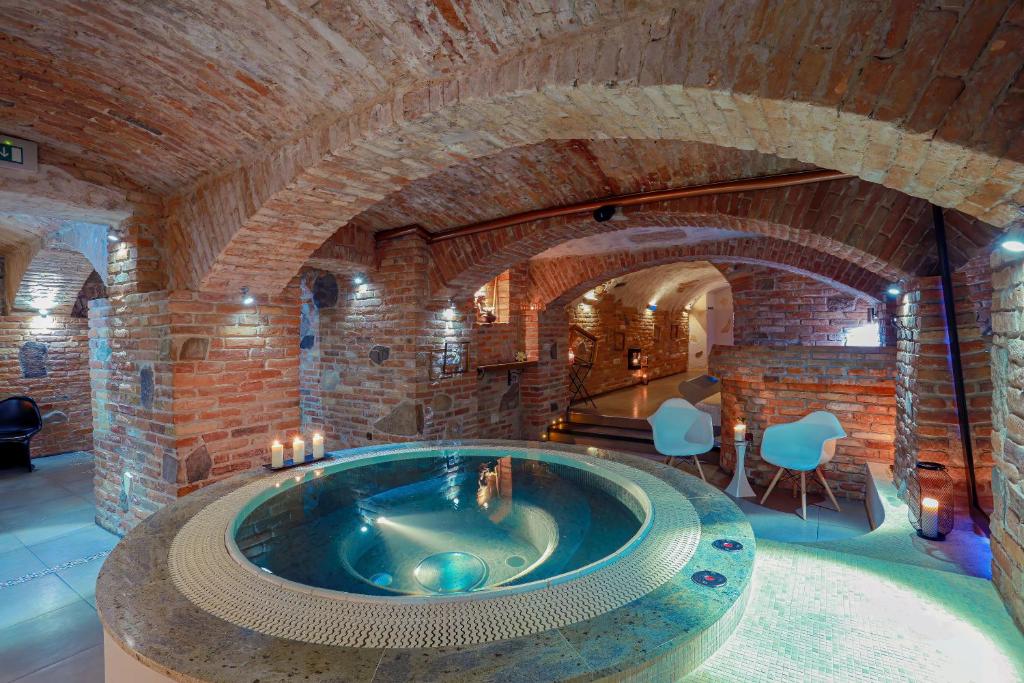 a large stone room with a jacuzzi tub at Penzion & Wellness Zoborska in Nitra