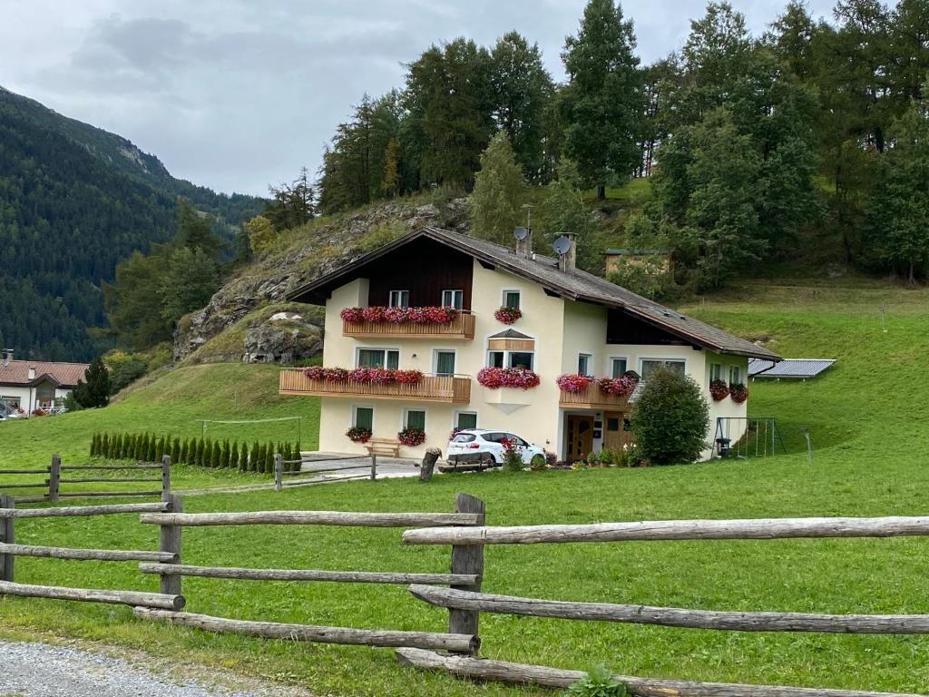 a house on a hill with a fence at Garni Schanz in Resia