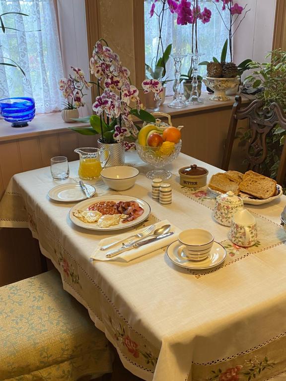 a table with a table cloth with food on it at Jeffrey’s B and B 