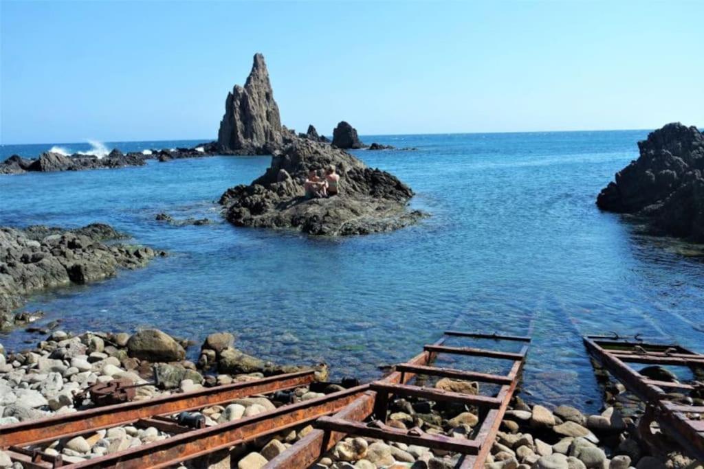 a pair of train tracks in the water with rocks at descanso al fin y al Cabo in El Cabo de Gata