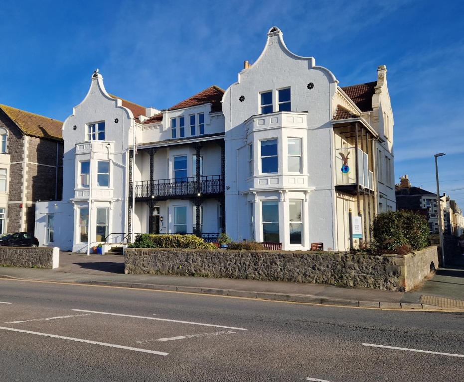 a large white house on the side of the street at The Beach Weston in Weston-super-Mare