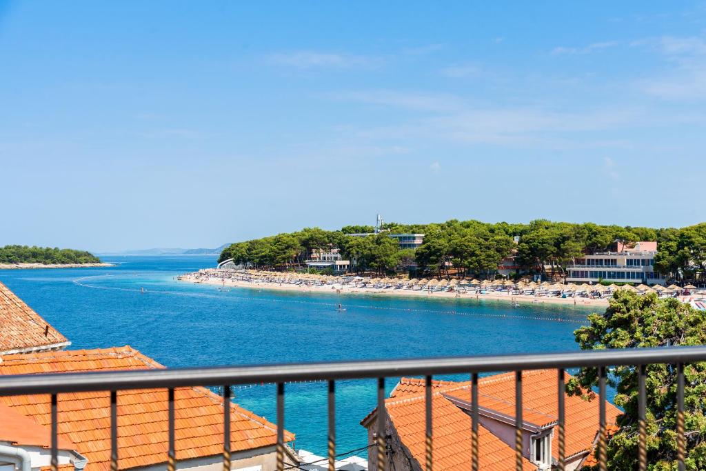 a view of a beach from a balcony at Luxury apartments Azalea Primošten in Primošten