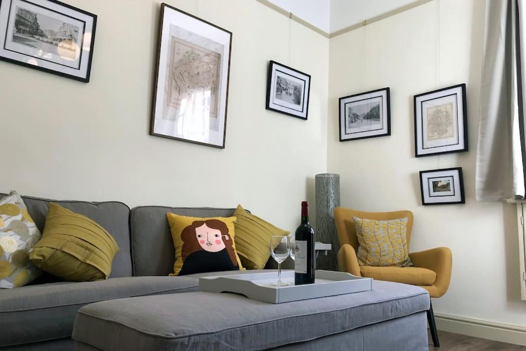 a living room with a couch and a table at Grade II Townhouse, Ledbury in Ledbury