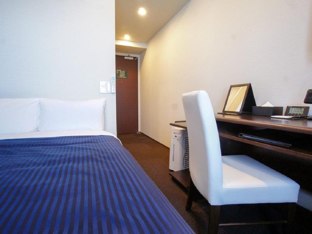 Postel nebo postele na pokoji v ubytování HOTEL LiVEMAX Yokohama Motomachi Ekimae