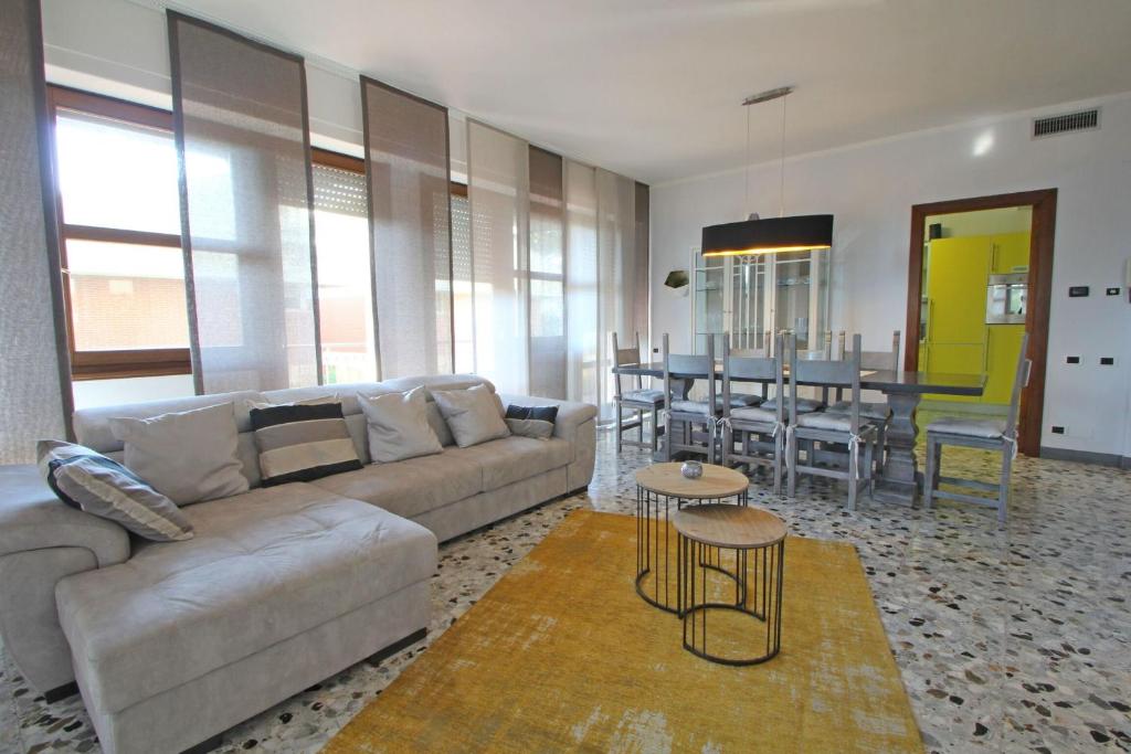 a living room with a couch and a table at Appartamento Dei Ronchi in Marina di Massa