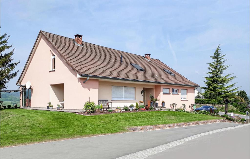 a white house with a brown roof at 2 Bedroom Amazing Apartment In Erpeldange-remich in Erpeldange-lez-Bous