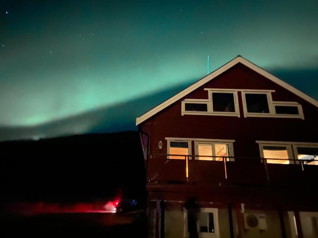 a house with the aurora in the sky at 3ART recreation in Tromsø