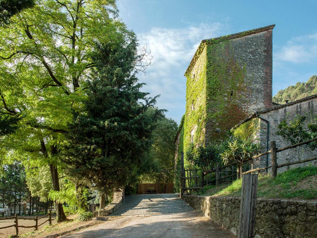 an alleyway next to a building with a tower at Les Canes 2 in Aiguafreda