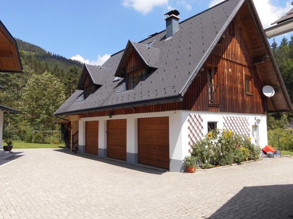 a barn with two garage doors and a roof at Ferienhaus Soghäusl in Göstling an der Ybbs