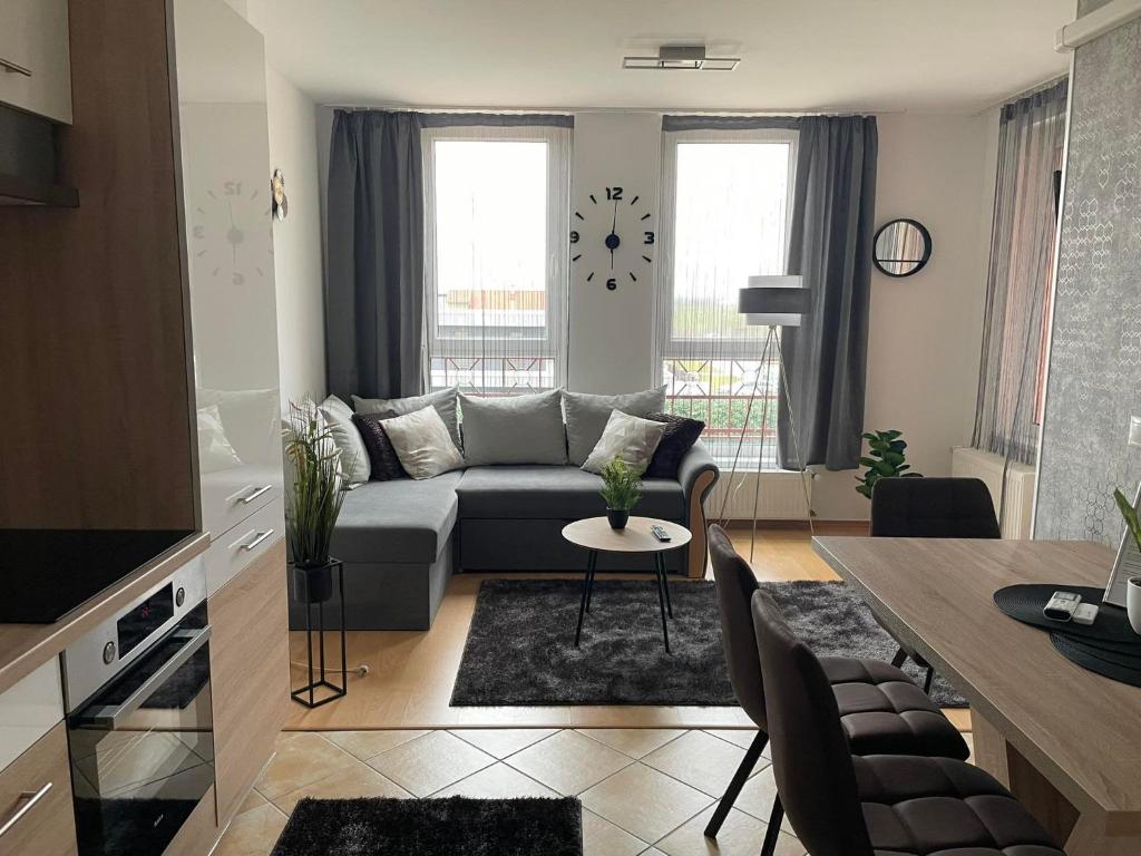 a living room with a couch and a table at Európa 20 Apartman in Bük