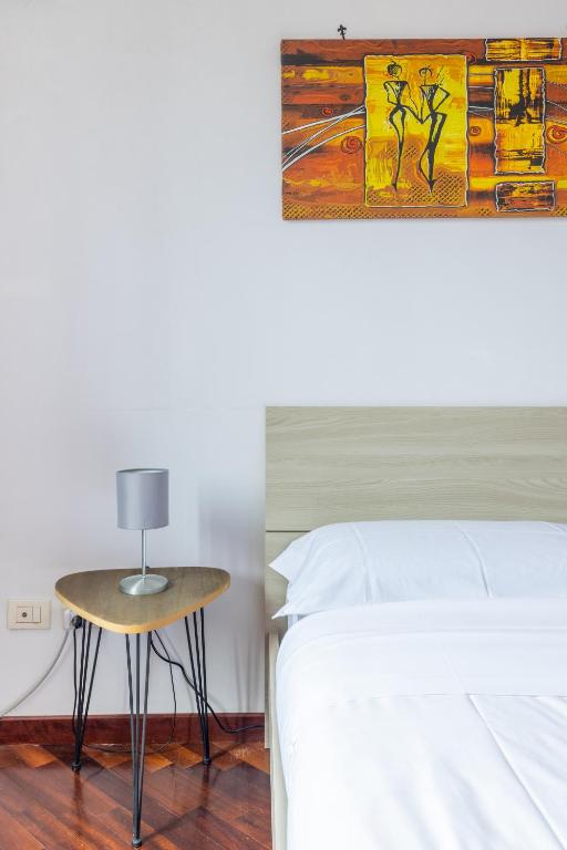 A bed or beds in a room at Smart Lodging Downtown
