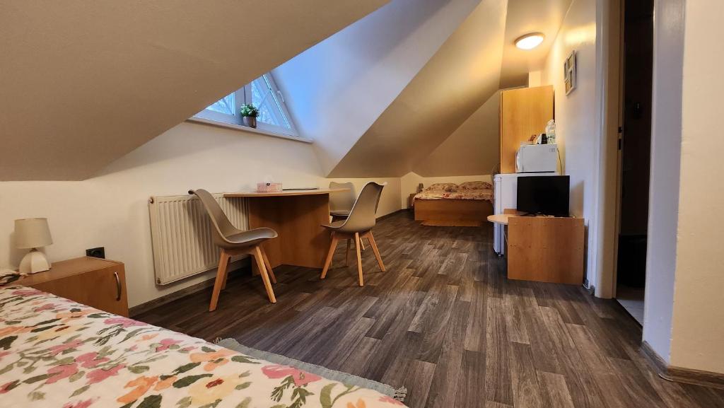 a bedroom with a bed and two chairs in a room at Penzion TCV Pardubice in Pardubice