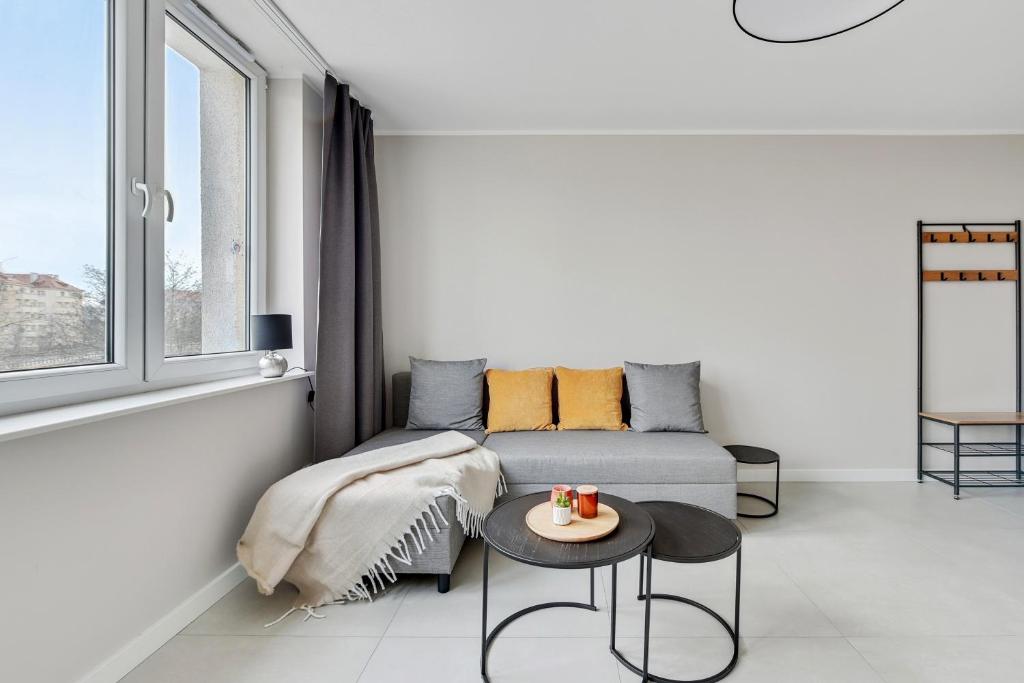 a living room with a couch and a table at Comfort Apartments Morska in Gdynia