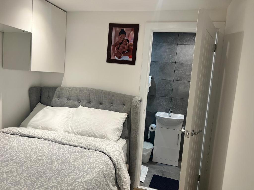 a small bedroom with a bed and a bathroom at AYOS in Dublin