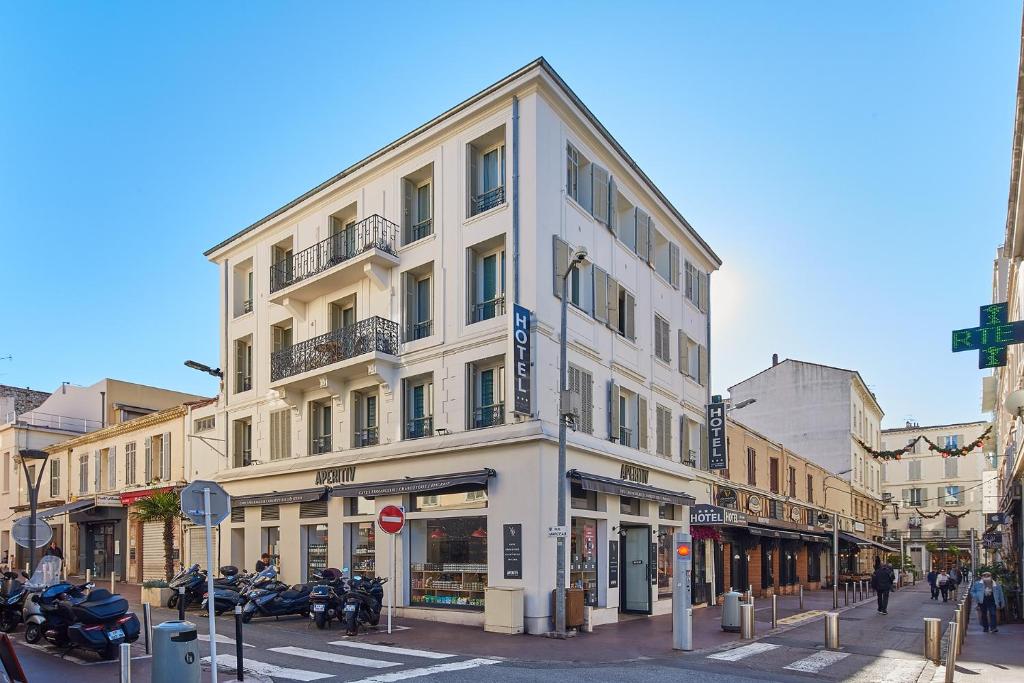 a tall white building on a city street at Hotel des Congrès et Festivals in Cannes