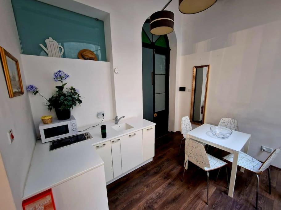 - une cuisine et une salle à manger avec une table et un évier dans l'établissement Grand House of Character Valletta, à Il-Furjana