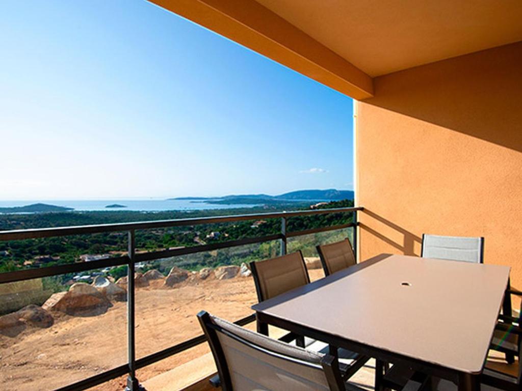 una mesa y sillas en un balcón con vistas en Apartment T3 premium vue mer by Interhome, en Zonza