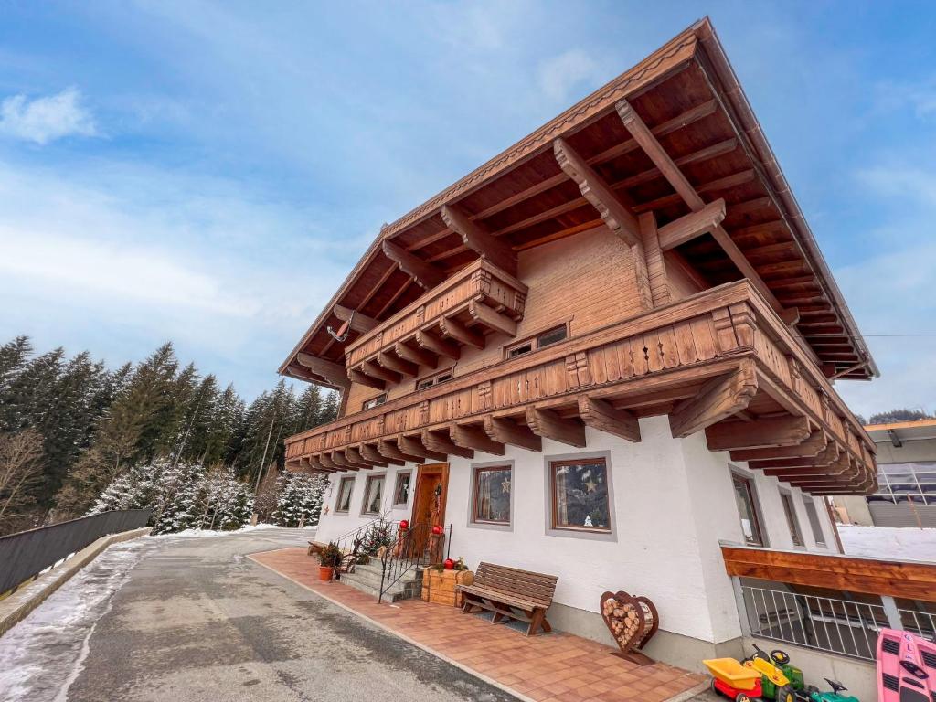 a house with a wooden roof on a street at Apartment App-1 by Interhome in Hollersbach im Pinzgau