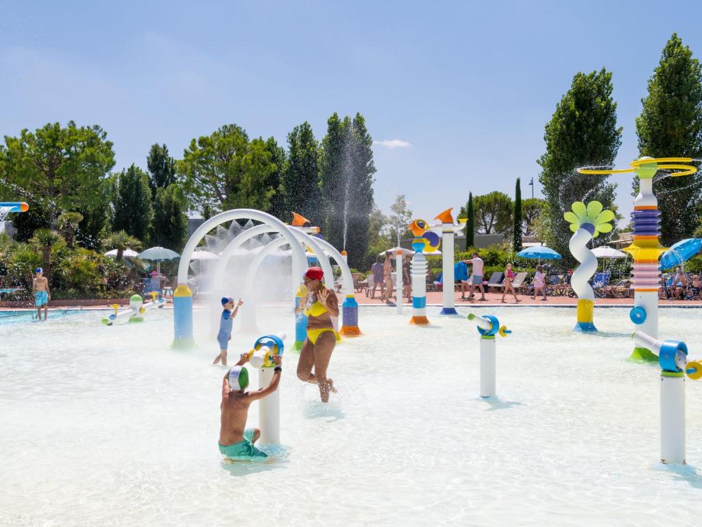 a group of children playing in a water park at Holiday Home San Francesco Camping Village by Interhome in Rivoltella
