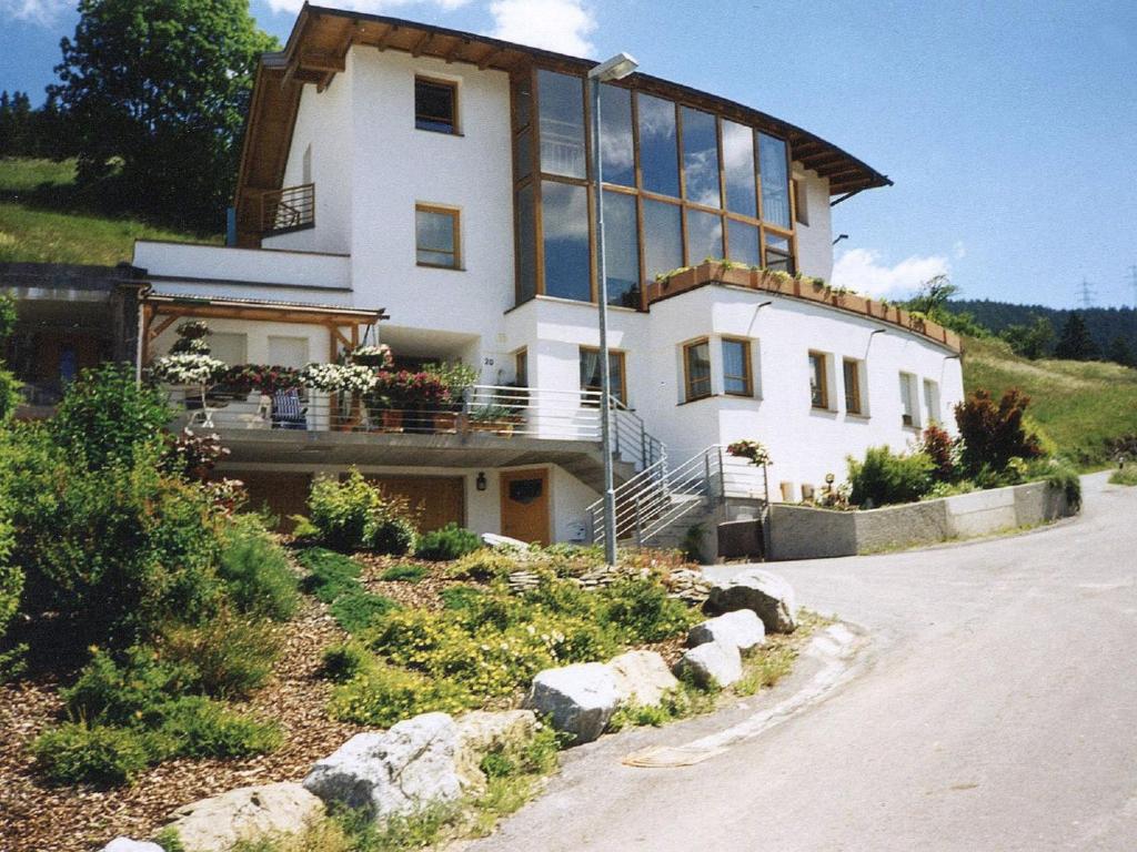 a large white house with glass windows on a hill at Apartment Schlatter by Interhome in Alterzoll