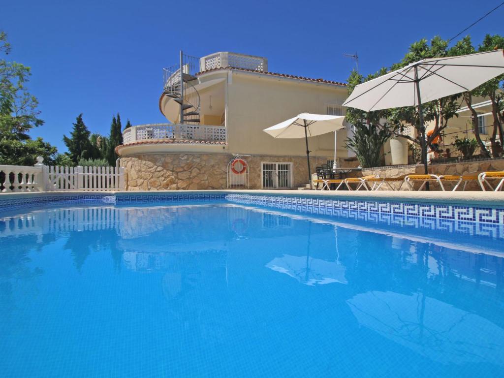 een zwembad voor een huis bij Villa Mercedes by Interhome in Casas de Torrat