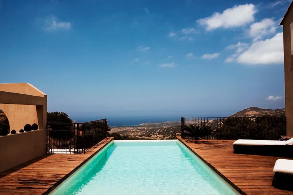 a swimming pool with a view of the ocean at VILLA BELLUCIA in Cateri