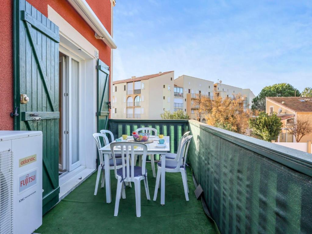 a patio with a table and chairs on a balcony at Apartment Eden Roc 2 by Interhome in Narbonne-Plage