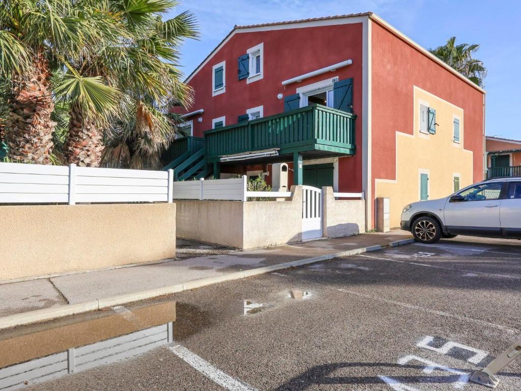 a car parked in a parking lot in front of a building at Apartment Eden Roc 2 by Interhome in Narbonne-Plage